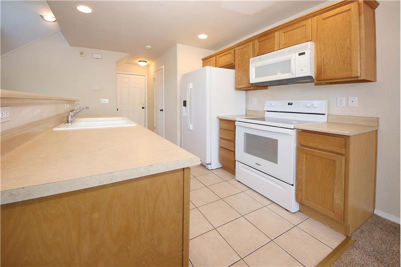 Appliances include a smoothtop range oven, microwave, dishwasher, and refrigerator