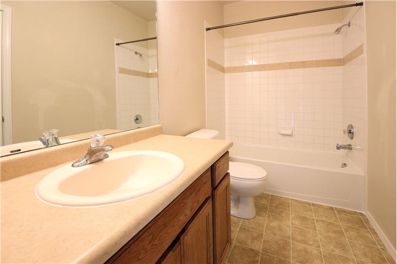 Upper-level full hall Bathroom with vanity and tub/shower