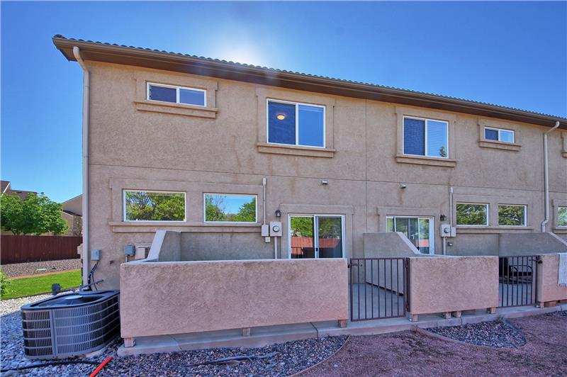 Rear view of home and walled patio