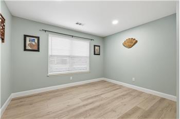 Large room with French doors could be a nice office, game room, or formal dining space