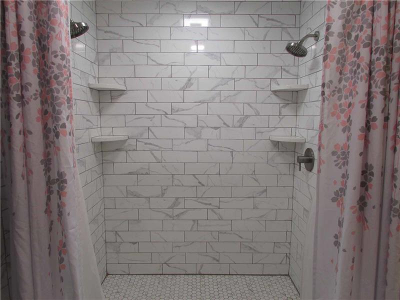 Owner's suite with tiled shower & dual shower heads