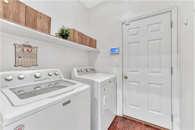 Laundry room with a door leading to 2-car attached garage