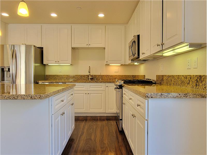 Recessed, Under Cabinet & Pendant Lighting up top! Down low, Laminate Flooring for protection against the sand/easy clean up!