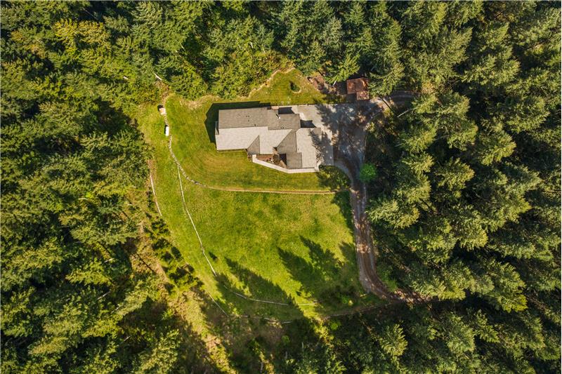 Overhead shot showing pull-through driveway and nicely cleared land providing a large private yard.