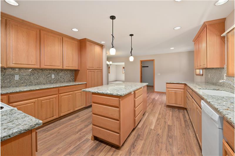 The many cabinets and built-in pantry provide an abundance of storage to store all of your appliances. The door at the far wall 