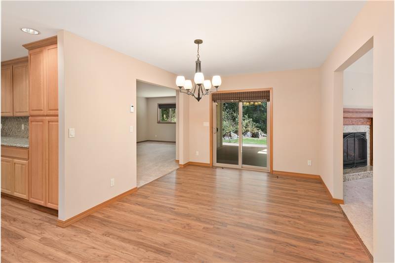 The dining room divides two separate living spaces, providing flexibility to suit your lifestyle. Sliding-door leads to a covere