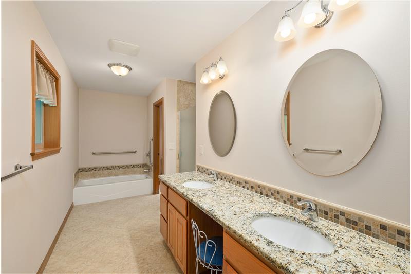 Master Bath with dual sink, vanity, separate tub & showers, plus a private space for the commode.