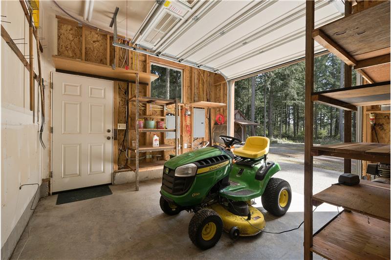 The third bay is large enough for a small tractor or turn it into your workshop with separate roll-up door! Electrical panel is 