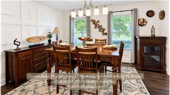 The dining room with full-wall and half-wall wainscoting frame the space
