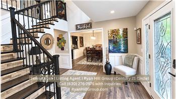 Decorative wood-and-glass front door into an 11-by-11-foot foyer.