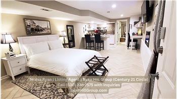 Lower-level s features living and sleeping area, kitchenette, full bathroom, office workstation, closet, and electric fireplace.