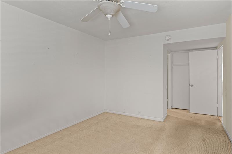 Bedroom One with Built In Storage behind Door