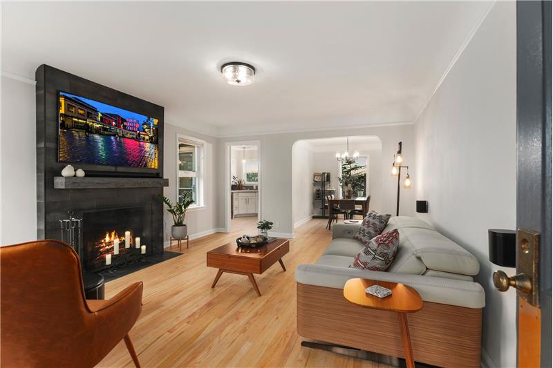 New fireplace surround, newly refinished wood floors. 