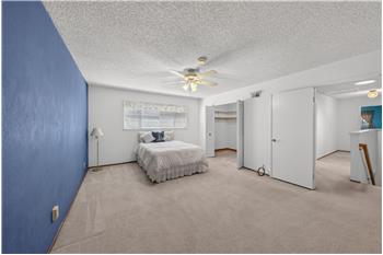 Primary Bedroom Showing Open Closet Doors