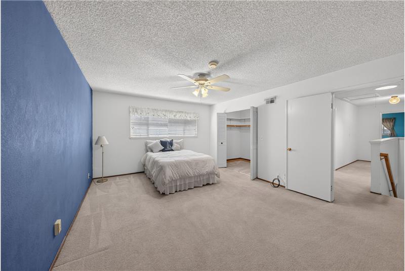 Primary Bedroom Showing Open Closet Doors