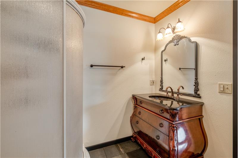 Primary ensuite bathroom with walk in shower and slate tile flooring