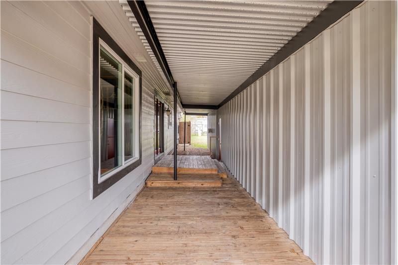 Breezeway leading to side entry between house and detached shop/garage