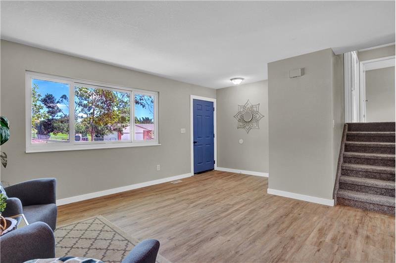Front entry into the Living Room with stairs to the upper and lower levels