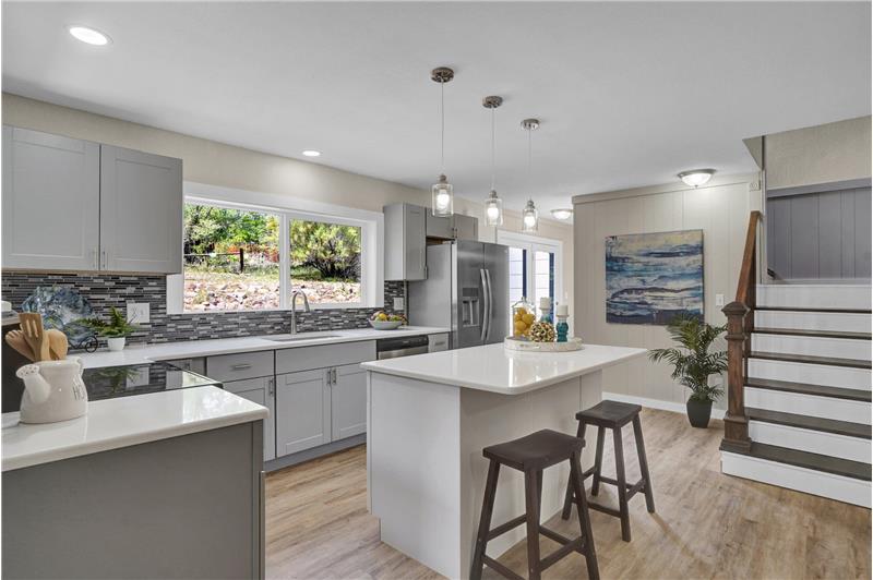 Gourmet Island Kitchen with stairs to the upper level