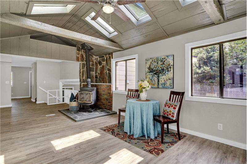 Vaulted Dining Room with lighted ceiing fan and skylights