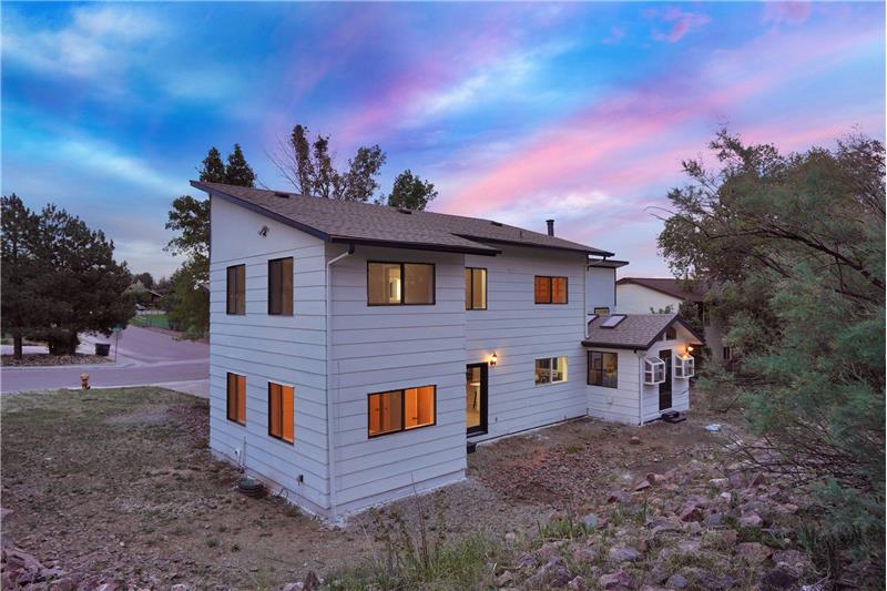 Sunset view of backyard and side yard