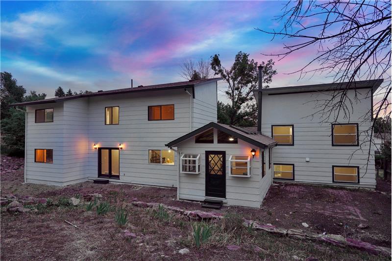 Sunset view of the rear of the house and backyard