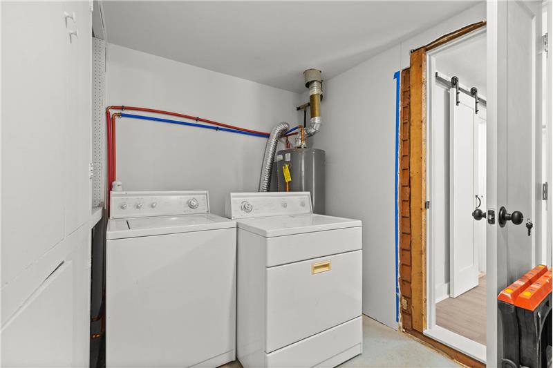 Laundry room with storage connects the two cottages