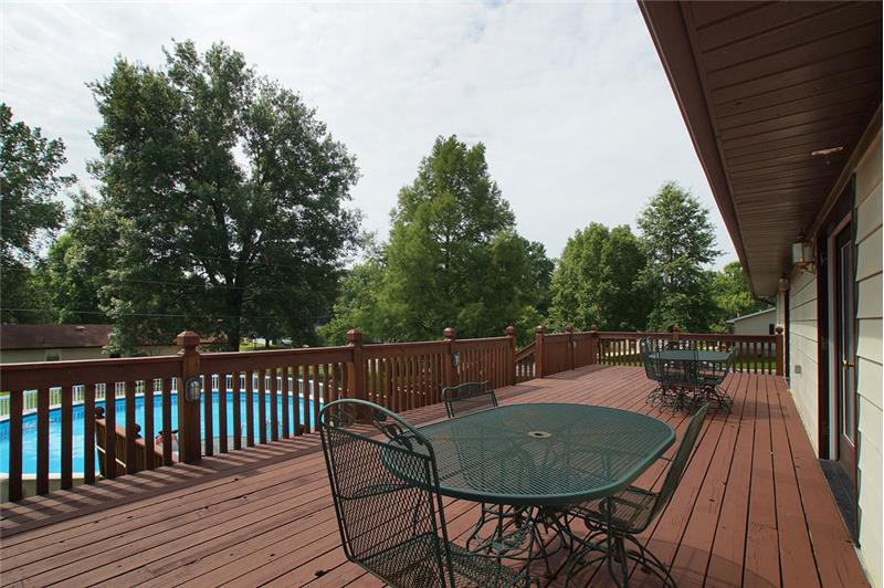 Deck overlooking pool and yard