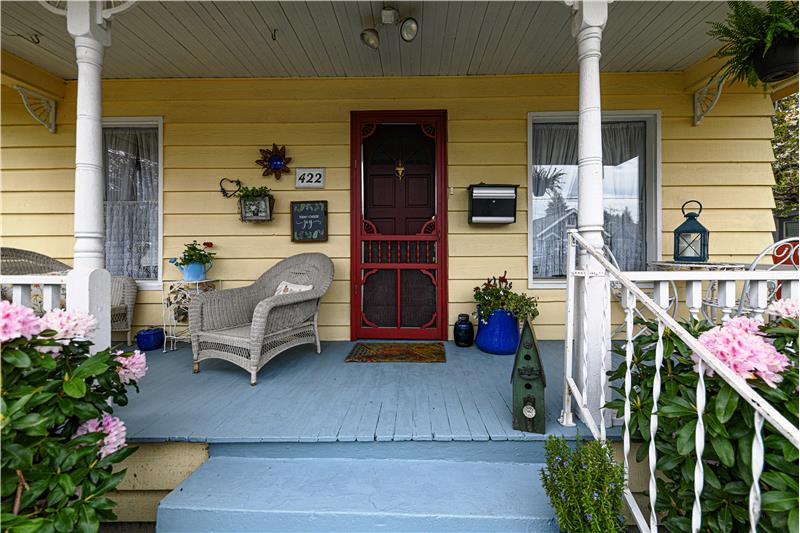 Covered porch that runs almost the length of the front of the home.