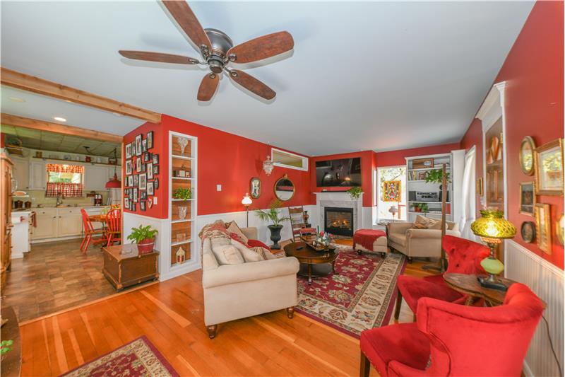 Living room with original fir flooring, MANY built in's, surround sound stereo receiver, and wall-mounted tv included.