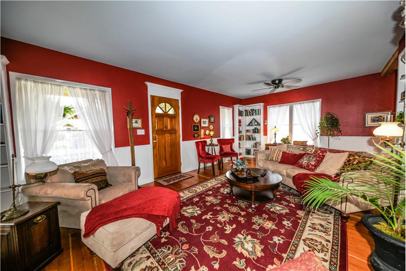 Another angle of this cozy living room. Ceiling fan, built in bookcases, so much more!