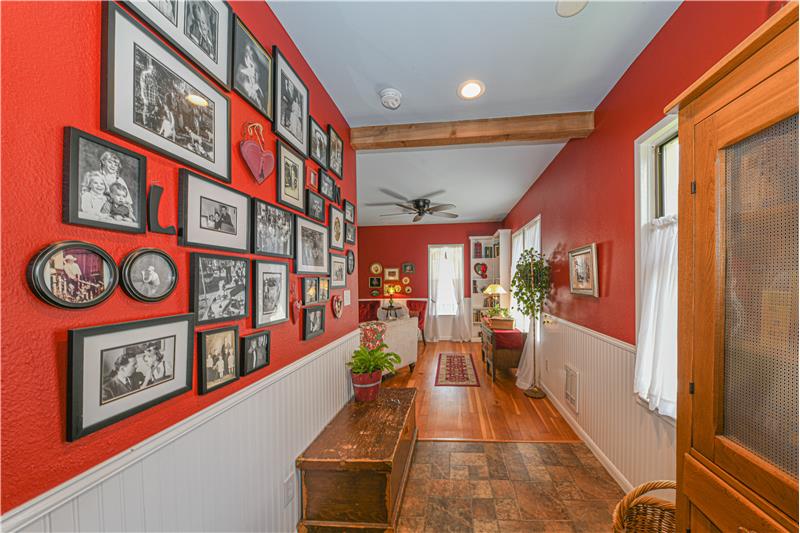 Hallway from living room to kitchen. Decorative wood wrapped beams.