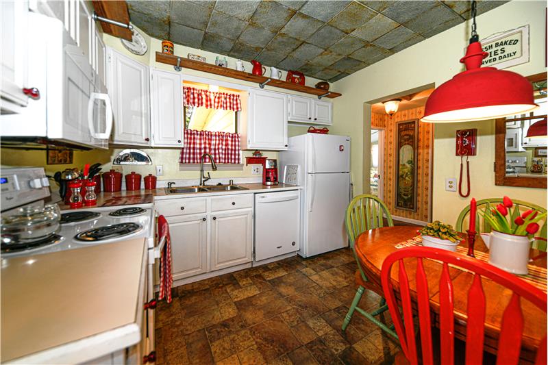 Kitchen with new flooring. New fridge, stove, dishwasher, garbage disposal, microwave, all included.
