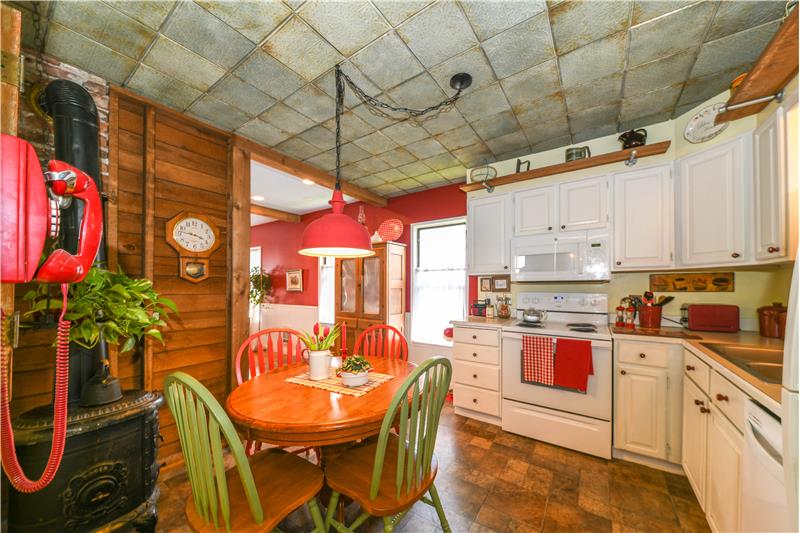 Another angle of kitchen. Wood stove and wall phone are deco only and not included in the sale of the home.