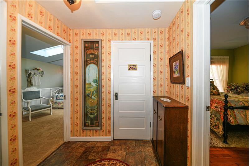 Hallway with original five-panel wood doors. This door in this picture goes to the bathroom.