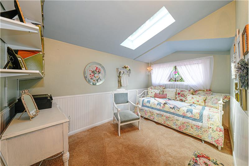 Secondary bedroom with skylight is light and airy. Carpet is three years old.