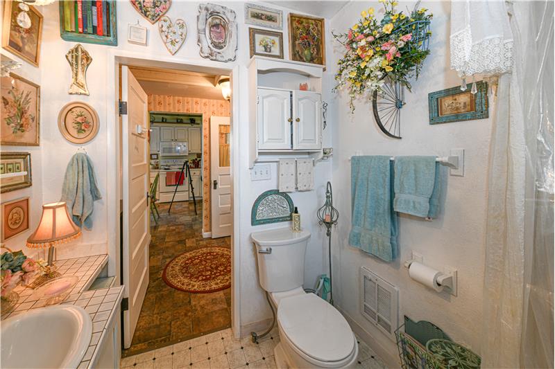 Thriee piece bathroom with new vinyl flooring and toilet.
