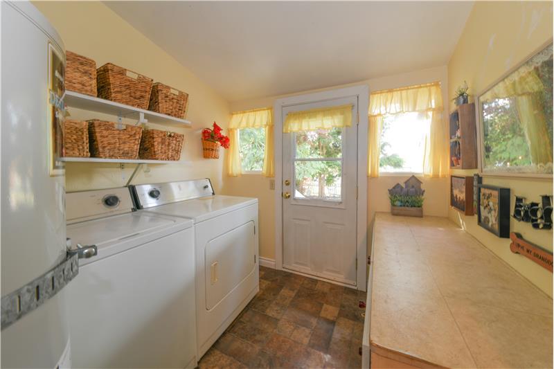 Utility room with new vinyl floors. Hot water tank in stree years old. Wonderful counterspace. Washer and dryer included.