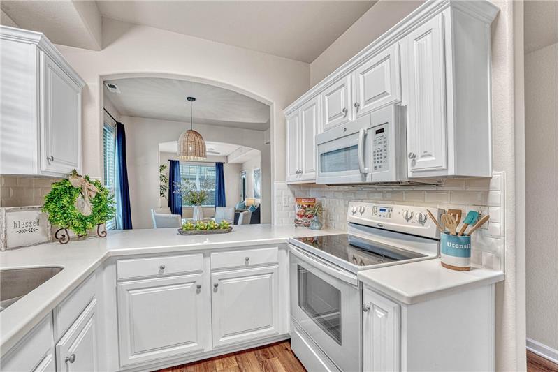 Updated lighting, smooth top range oven, and overhead microwave