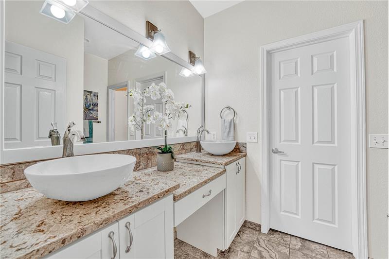 Updated bathroom with vessel sinks, granite, and tile. Large walk-in closet