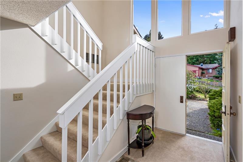 Large, bright entryway includes double doors and an adjacent coat closet