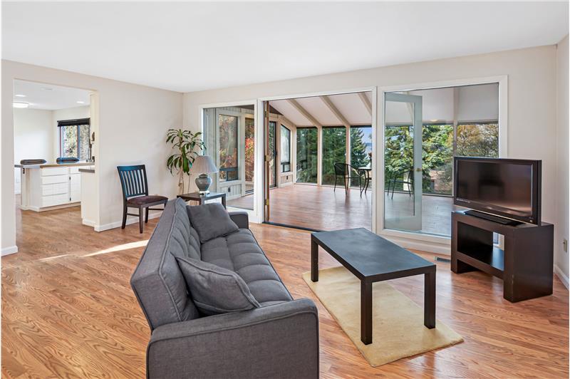 This flexible space next to the kitchen could be a family room or large dining space and opens to the adjacent atrium with a vie