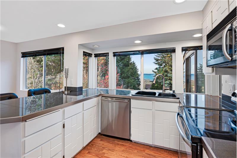 Enjoy the updated kitchen with stainless steel appliances and view of the sound.