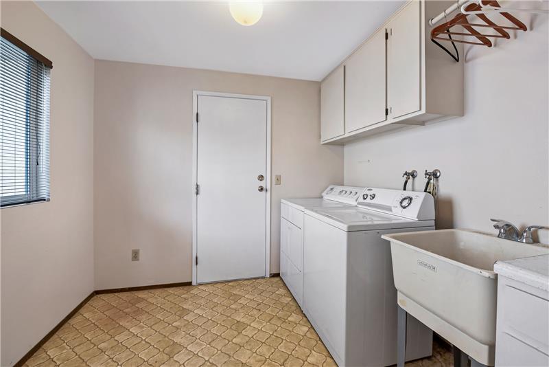 This mudroom/laundry room provides the perfect place to kick off your shoes on your way in from the garage.