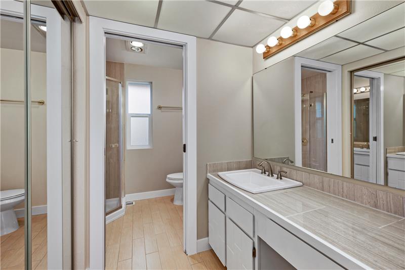 Your private bathroom in the primary suite features updates of tile throughout