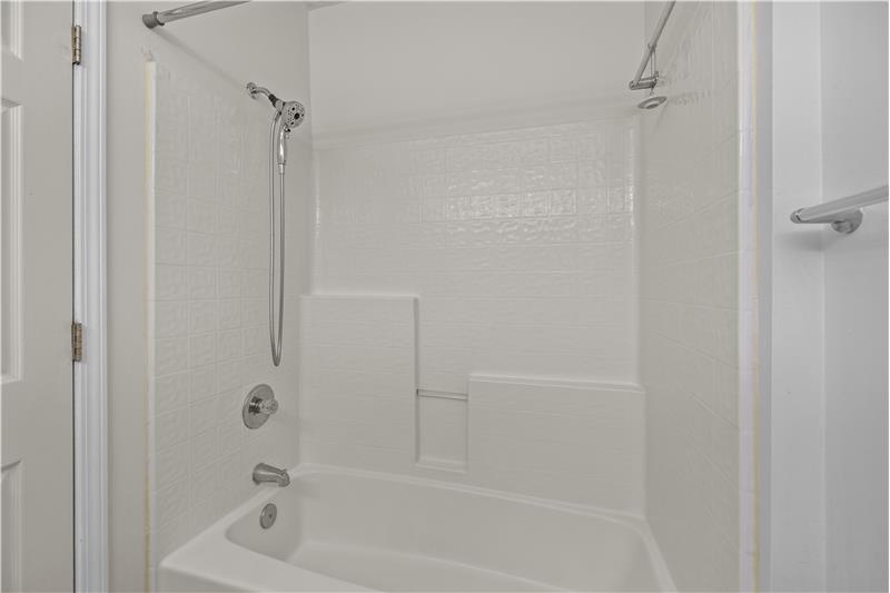 En-suite primary bath features a soaking tub/shower combination