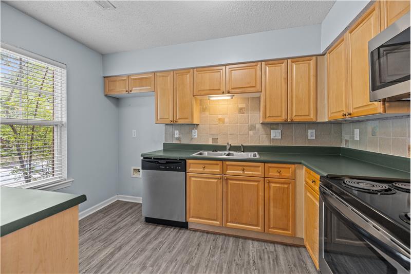 Windowed kitchen with stainless steel appliances