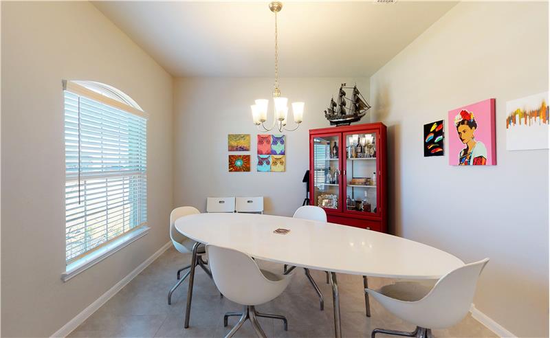 The dining room features a large window and ample room for your dining needs.