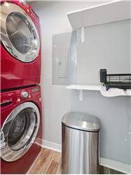 Stacked laundry and pantry off the kitchen.