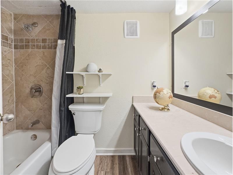 Primary bathroom with combo tub and shower.